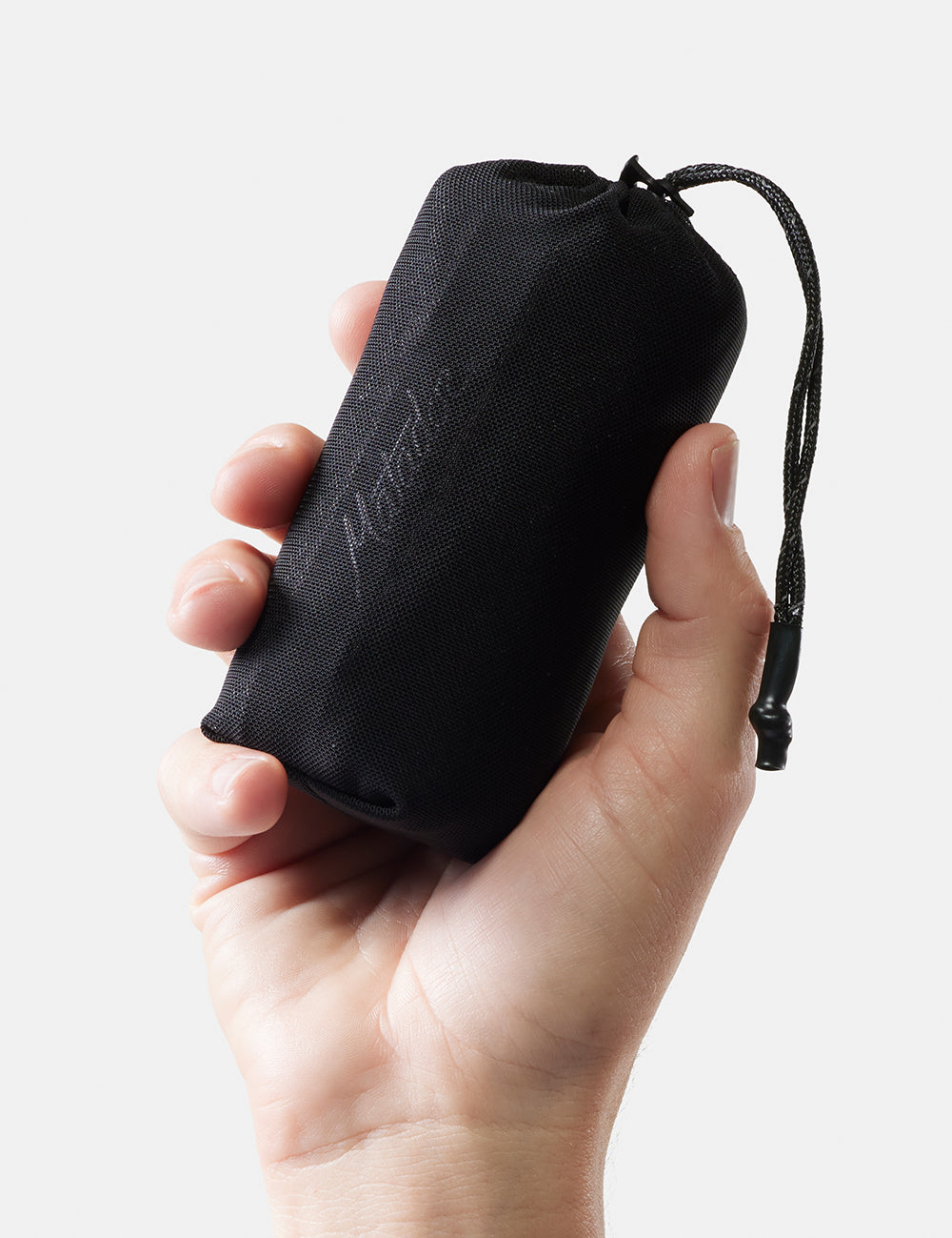 hand on white background holding packed up towel