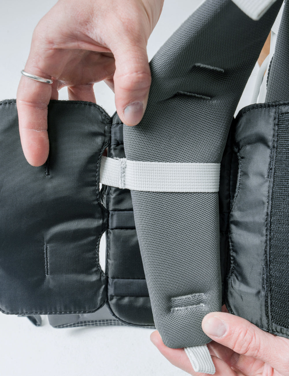 detail view of speed stash being attached to backpack strap