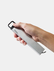 Hand holding a pill canister with 'matador' branding on a light gray background