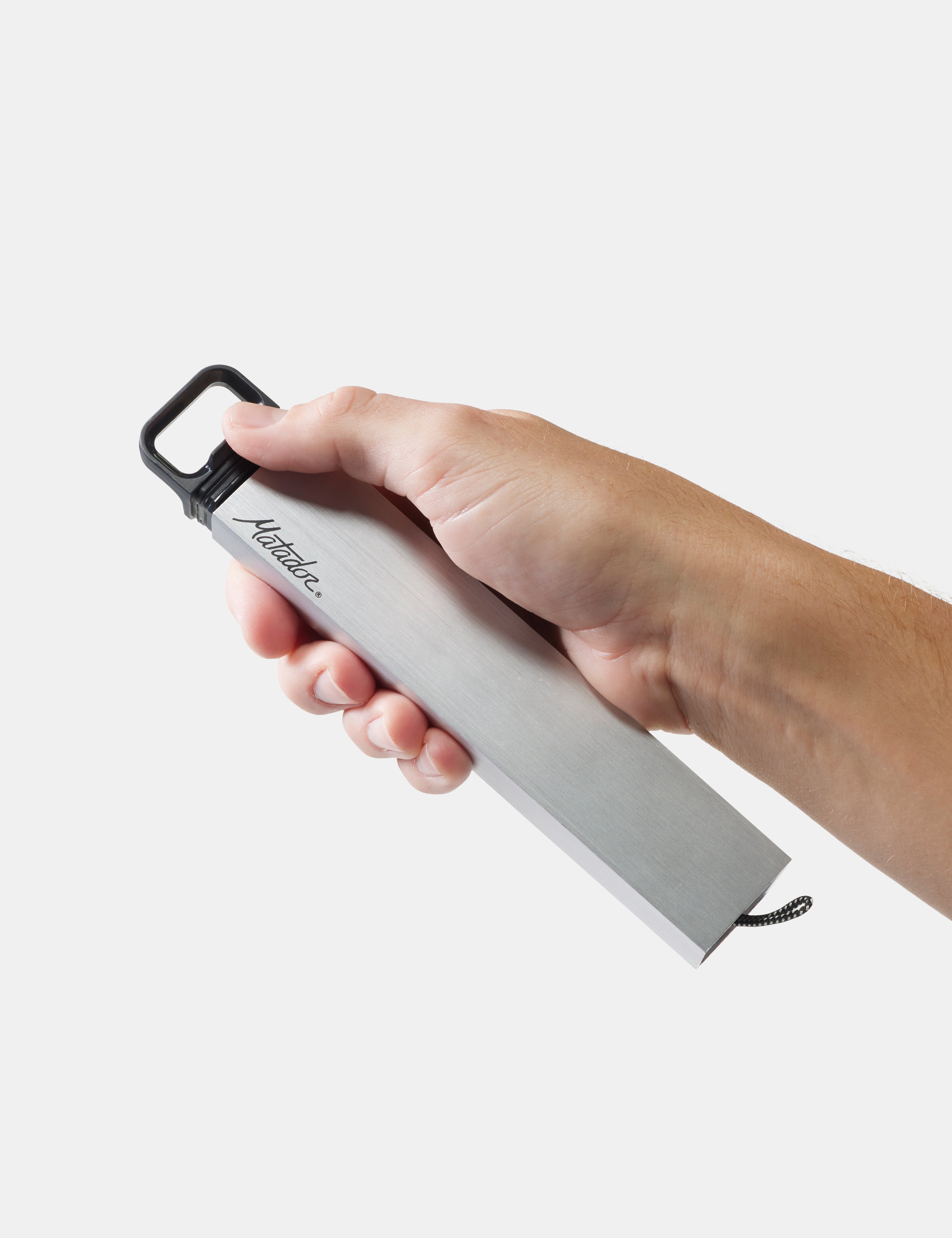 Hand holding a pill canister with 'matador' branding on a light gray background