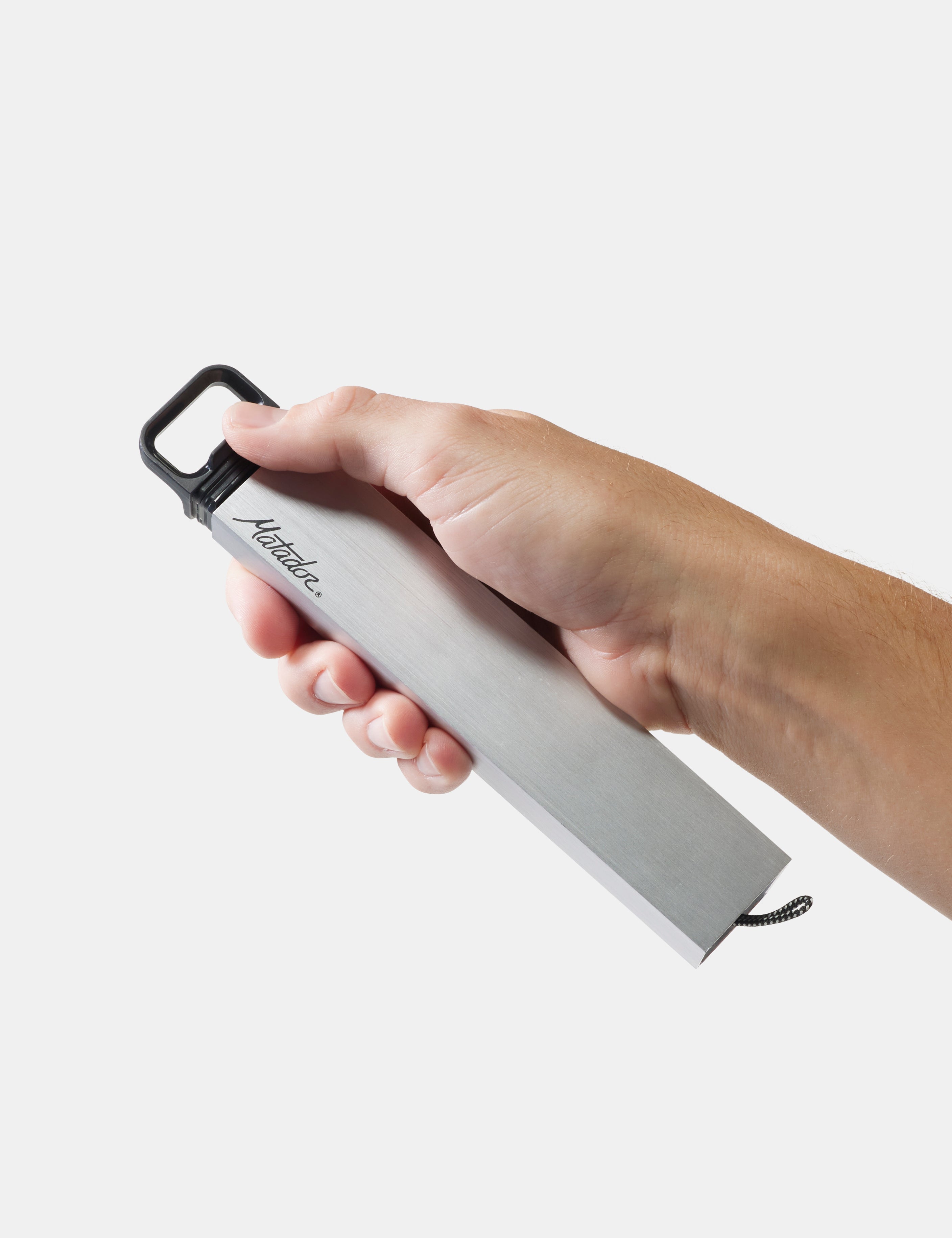 Hand holding a pill canister with 'matador' branding on a light gray background