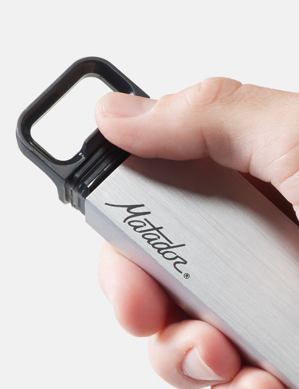 thumb pushing open pill canister