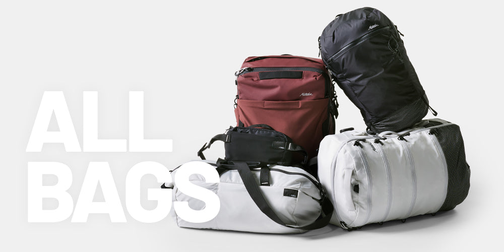 "All Bags" over a pile of black, white, and garnet Matador bags