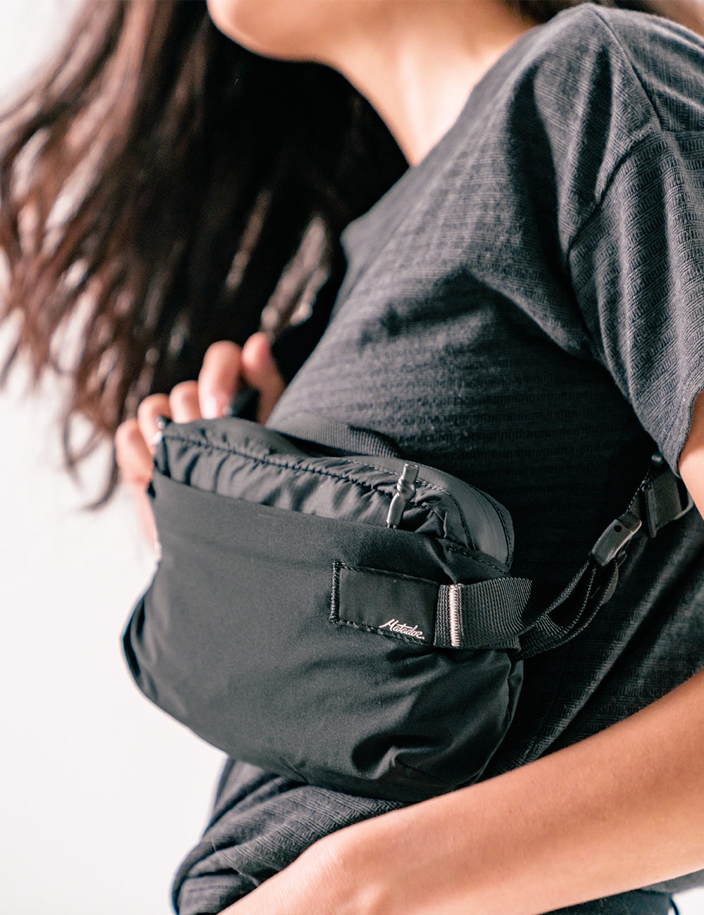 woman wearing black sling across her front