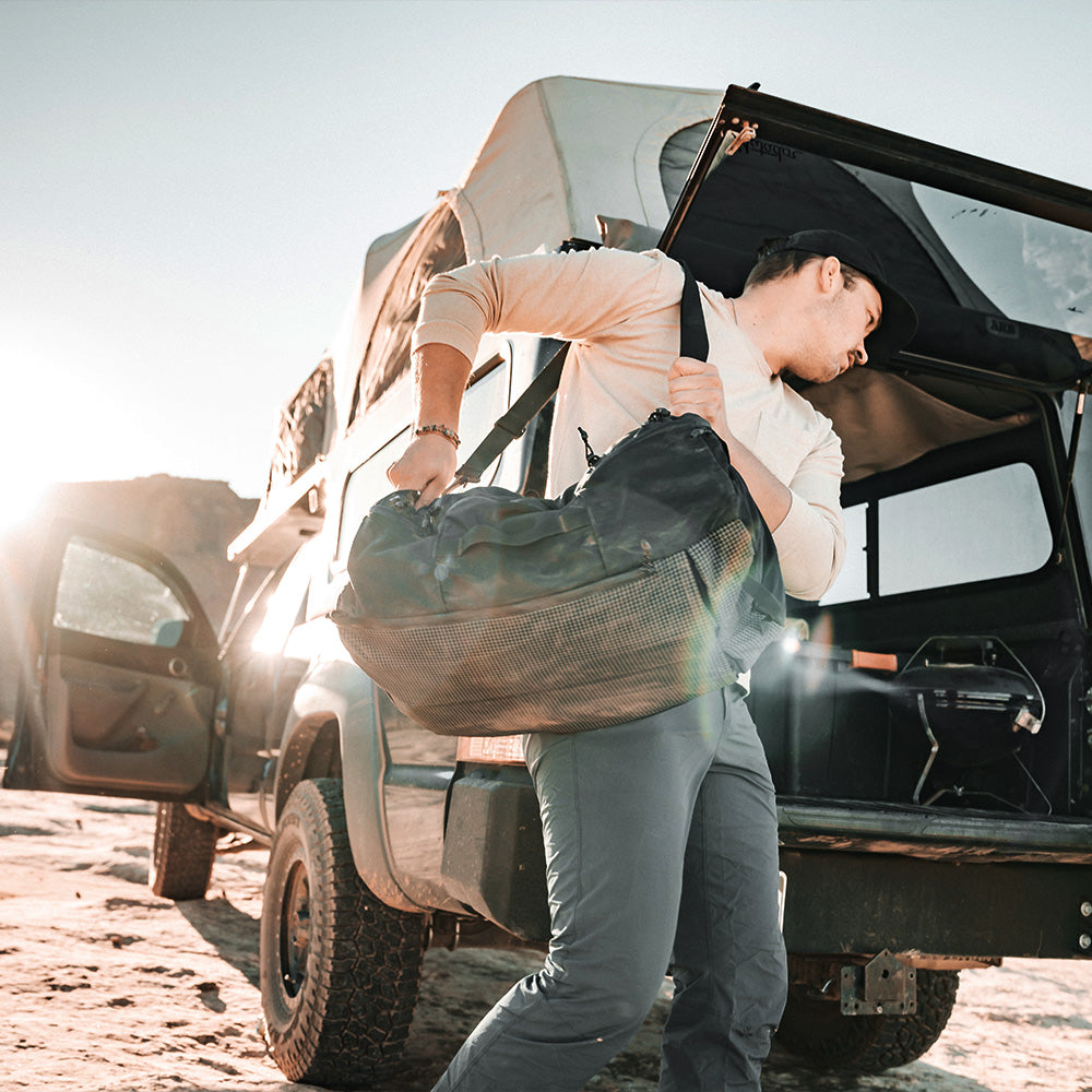 Man in desert, packing SEG45 Duffle into his trunk