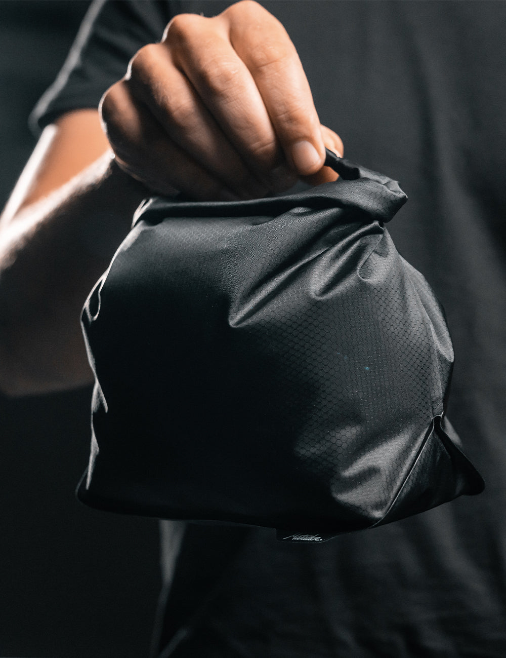 hand holding waterproof toiletry case