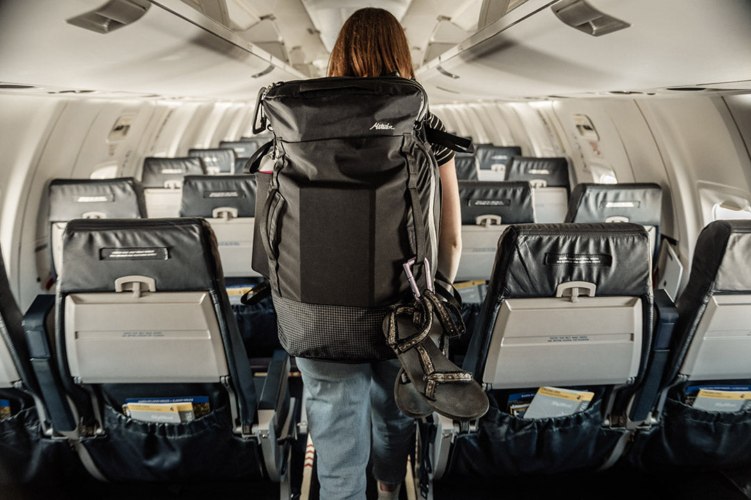 Girl boarding a plane with a matador backpack