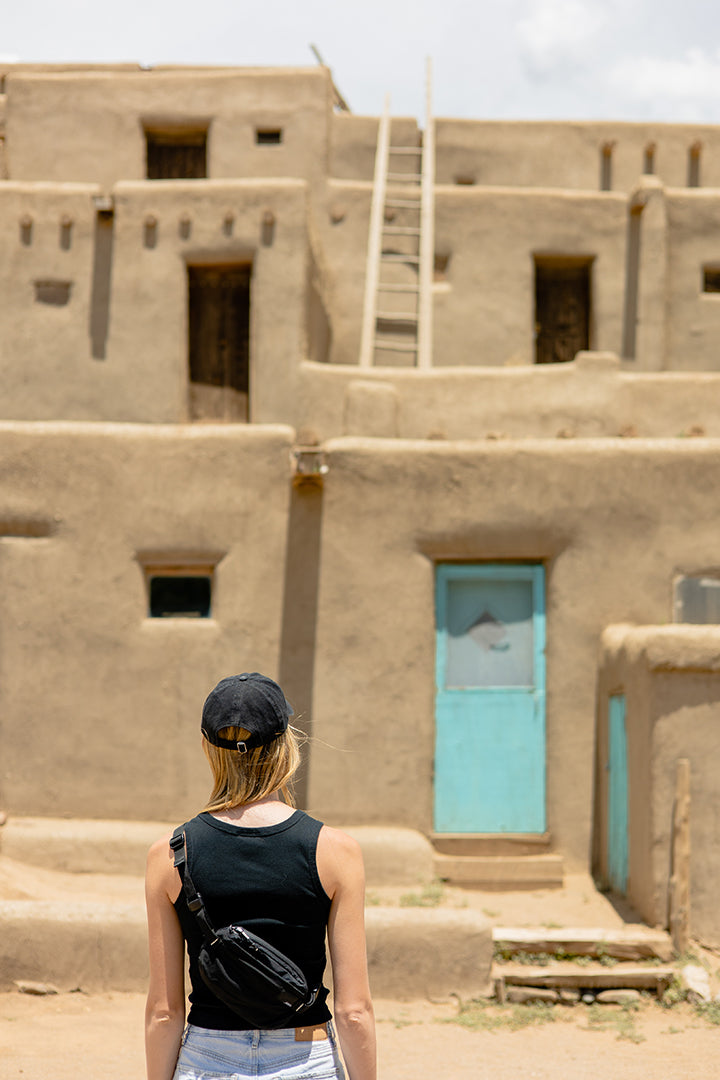 person looking at taos pueblo