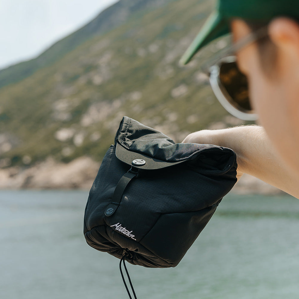 man holding camera base layer by bay