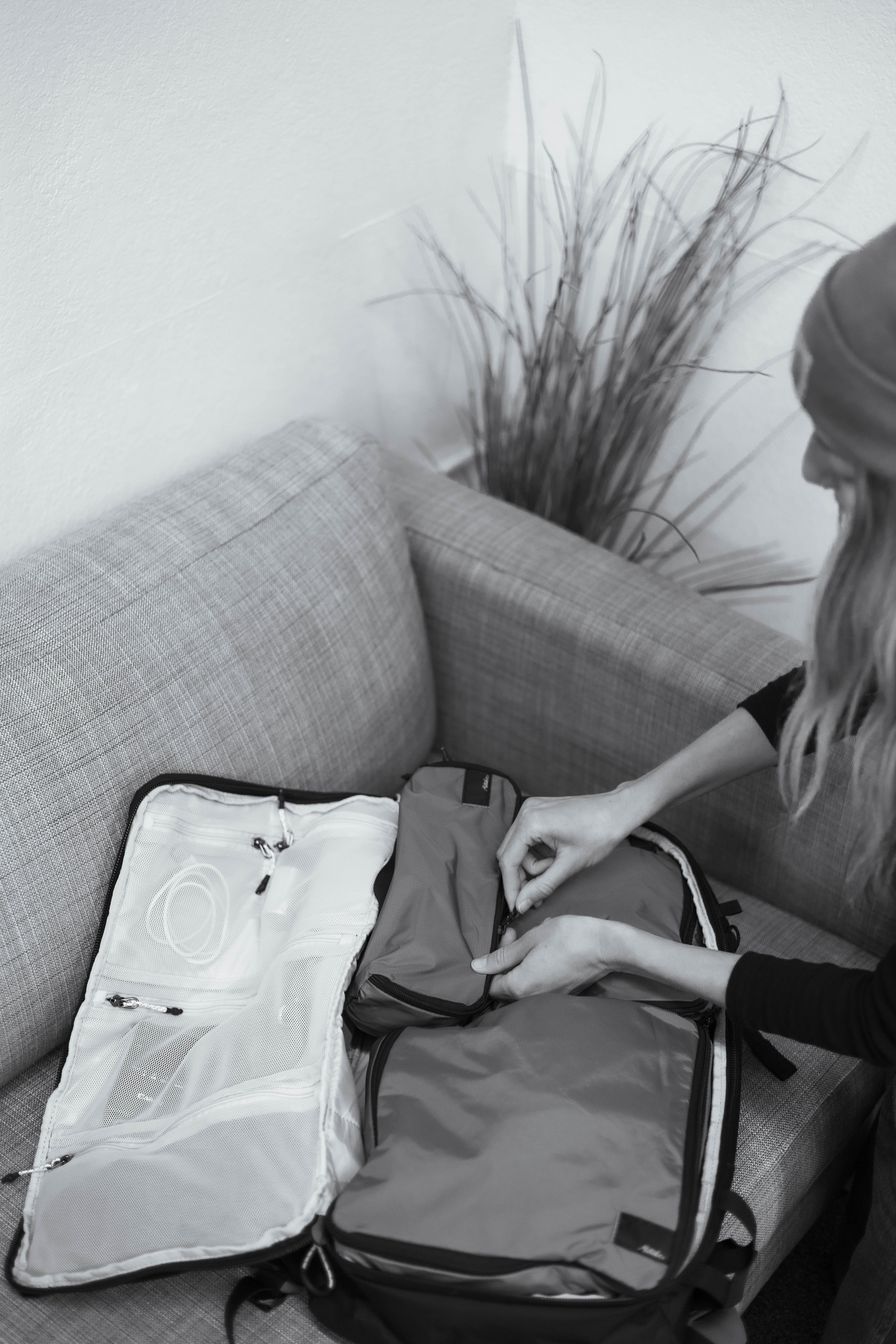 woman packing her backpack with packing cubes