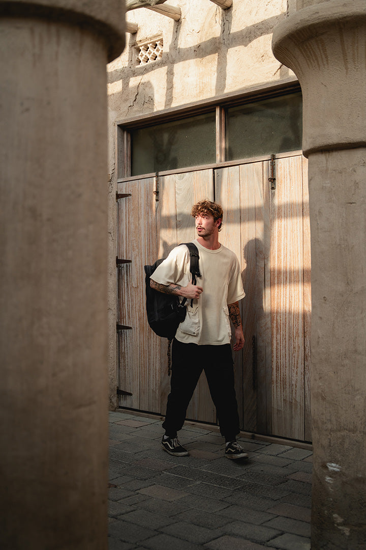 person on a last minute trip walking with a carry-on backpack