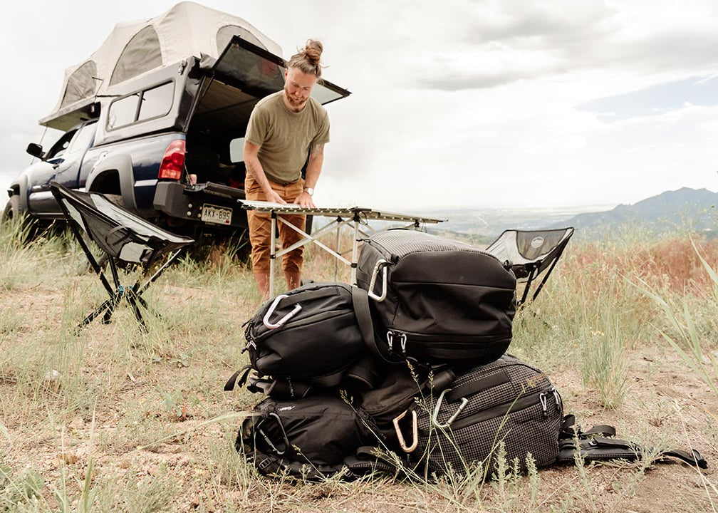 a man setting up camp on a car camping trip